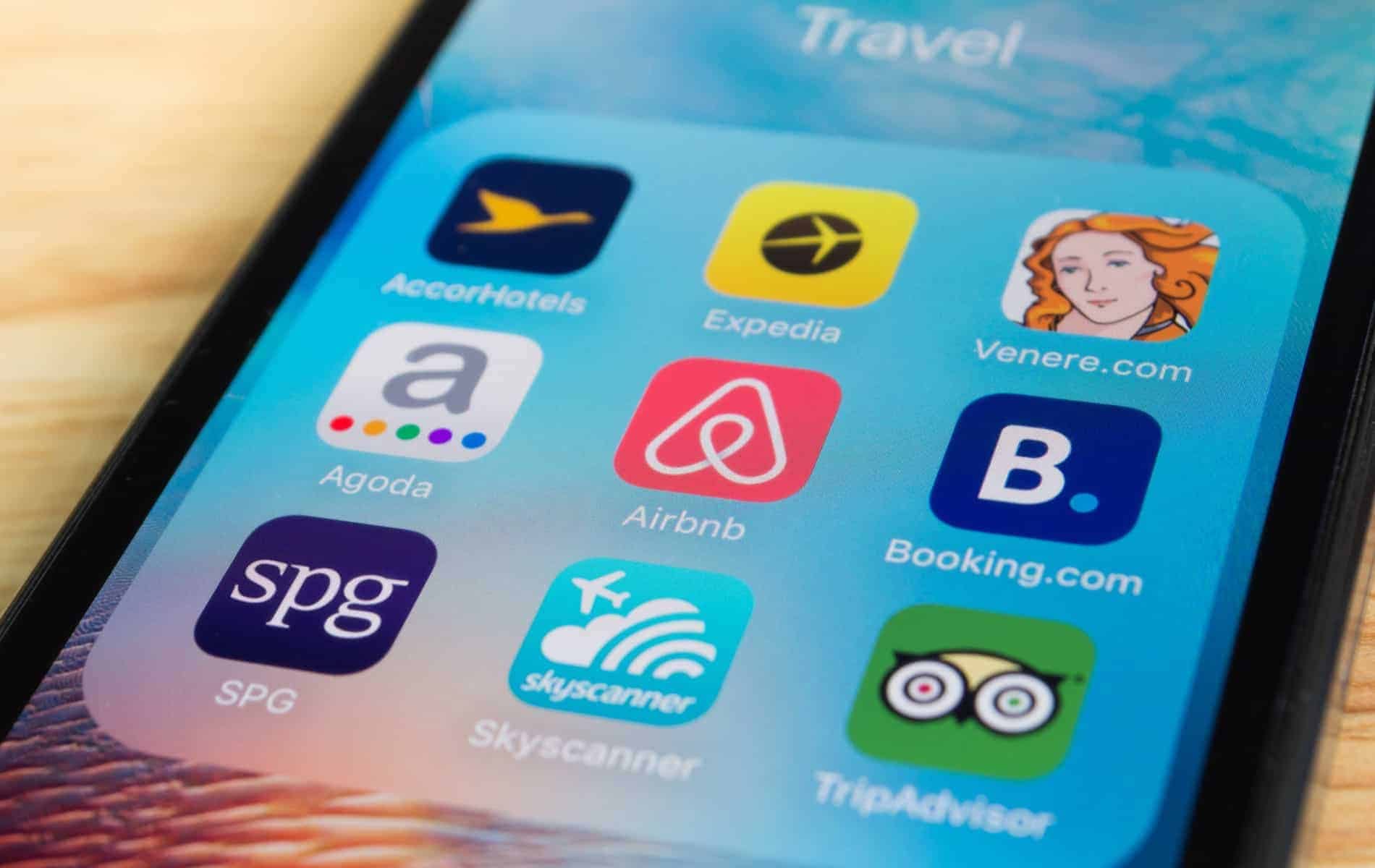 A smartphone with travel apps displayed on it, specifically tailored for managing properties in Mammoth Lakes.