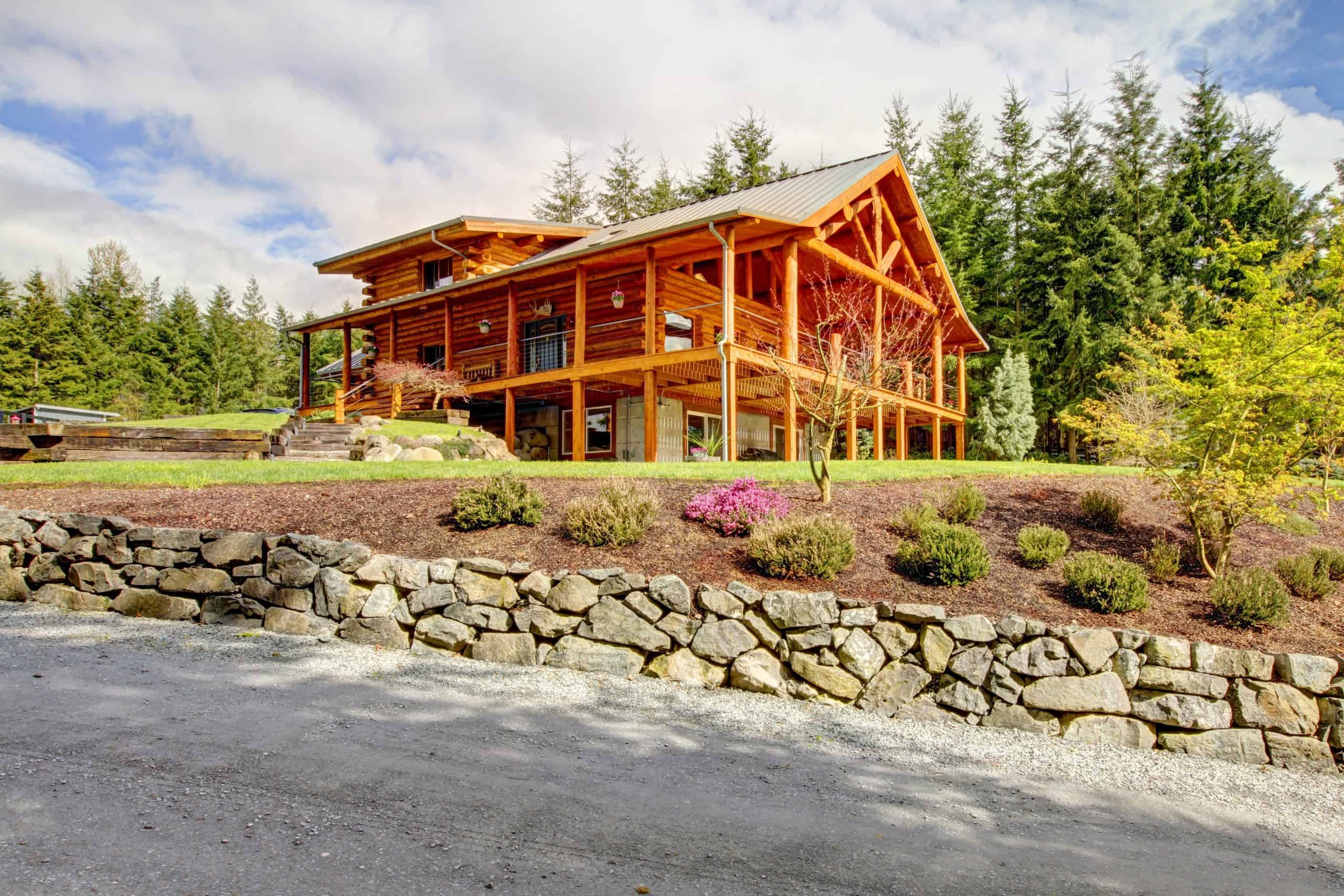 A large log cabin in the woods.