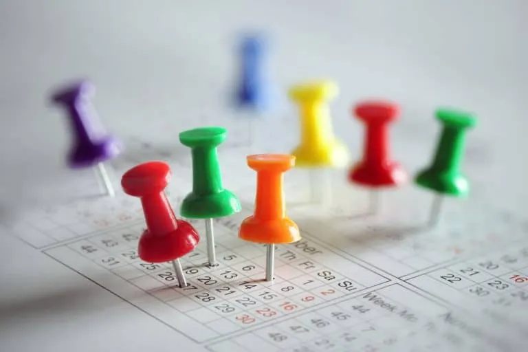 Colorful pins on a calendar.