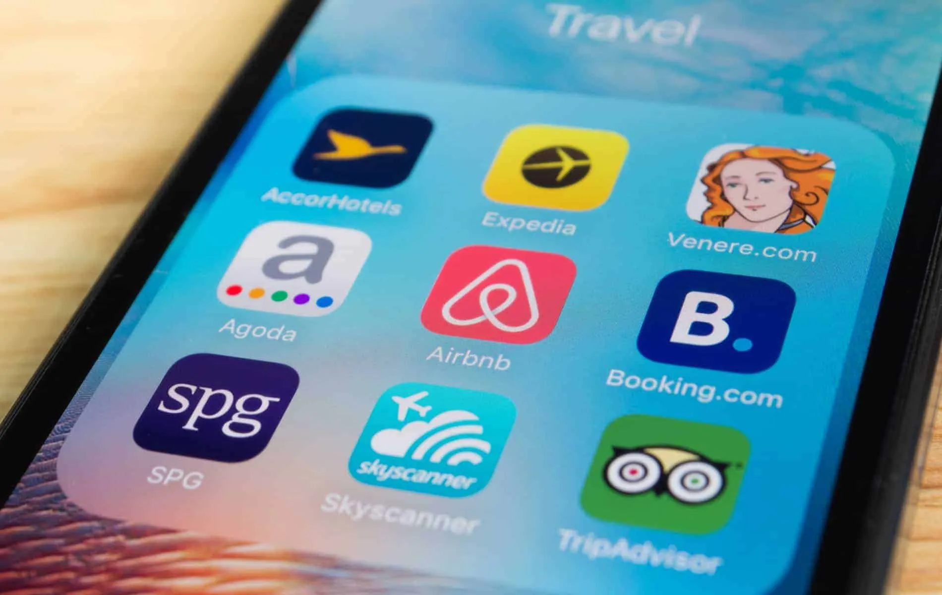 A smartphone with travel apps displayed on it, specifically tailored for managing properties in Mammoth Lakes.